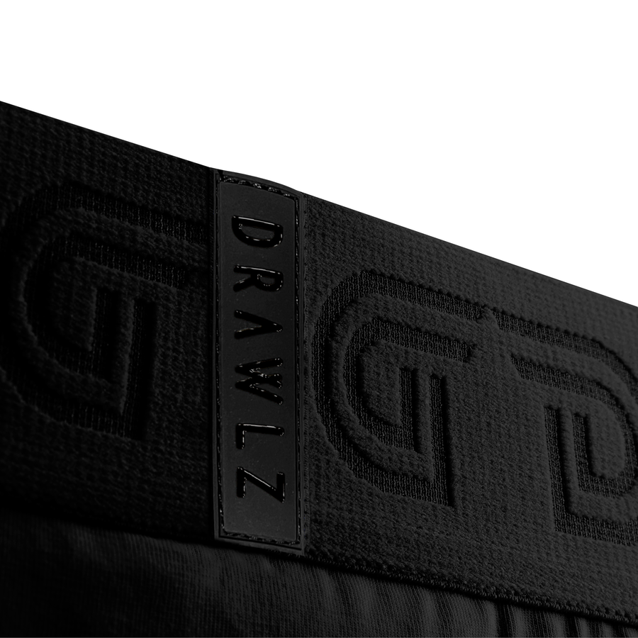 Cottonz Noir waistband detail with woven DG monogram — black cotton boxer briefs