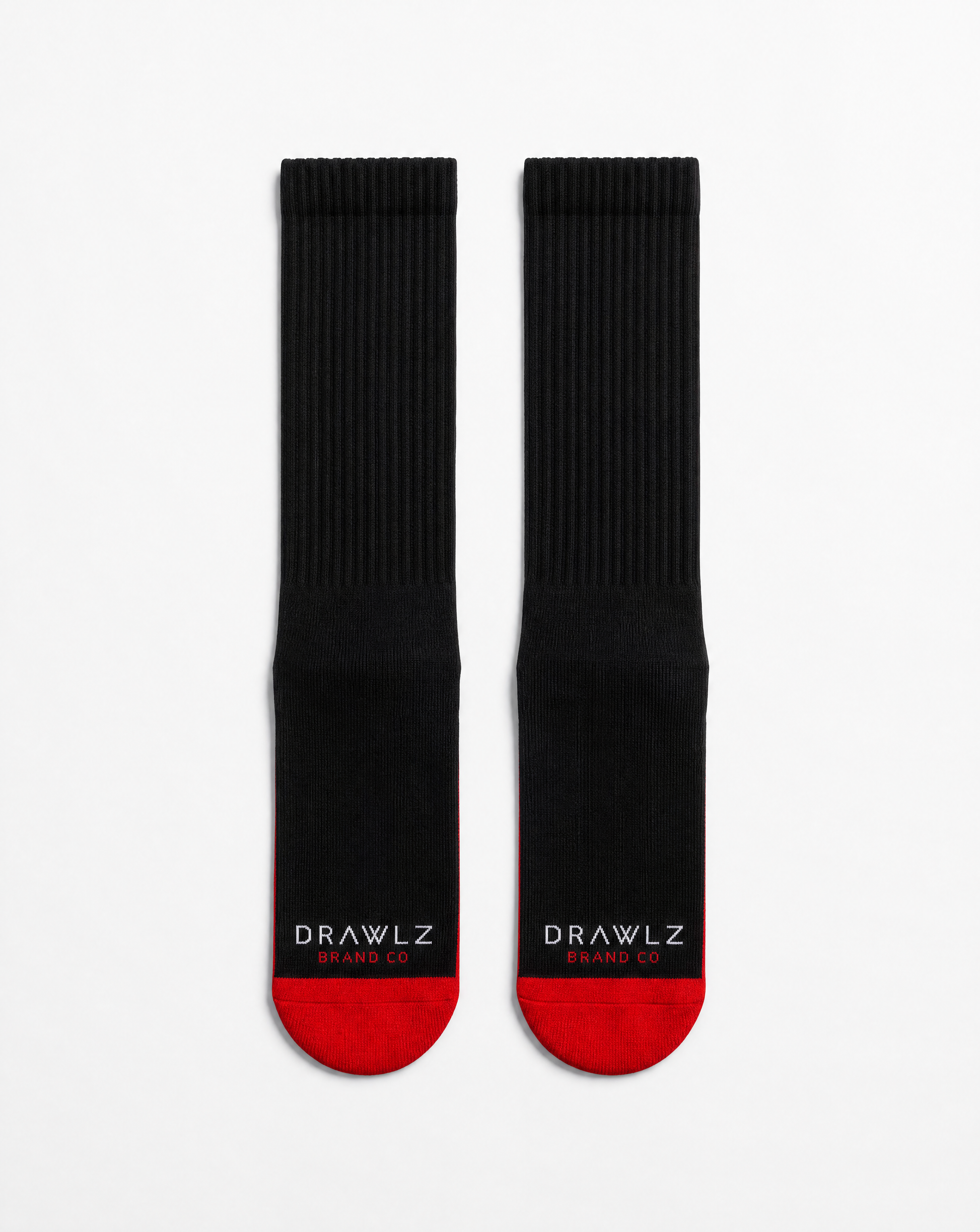 A pair of black crew socks with red toes and heels, featuring the white text 'DRAWLZ DESIGN CO.' printed on the soles, displayed against a clean white background.