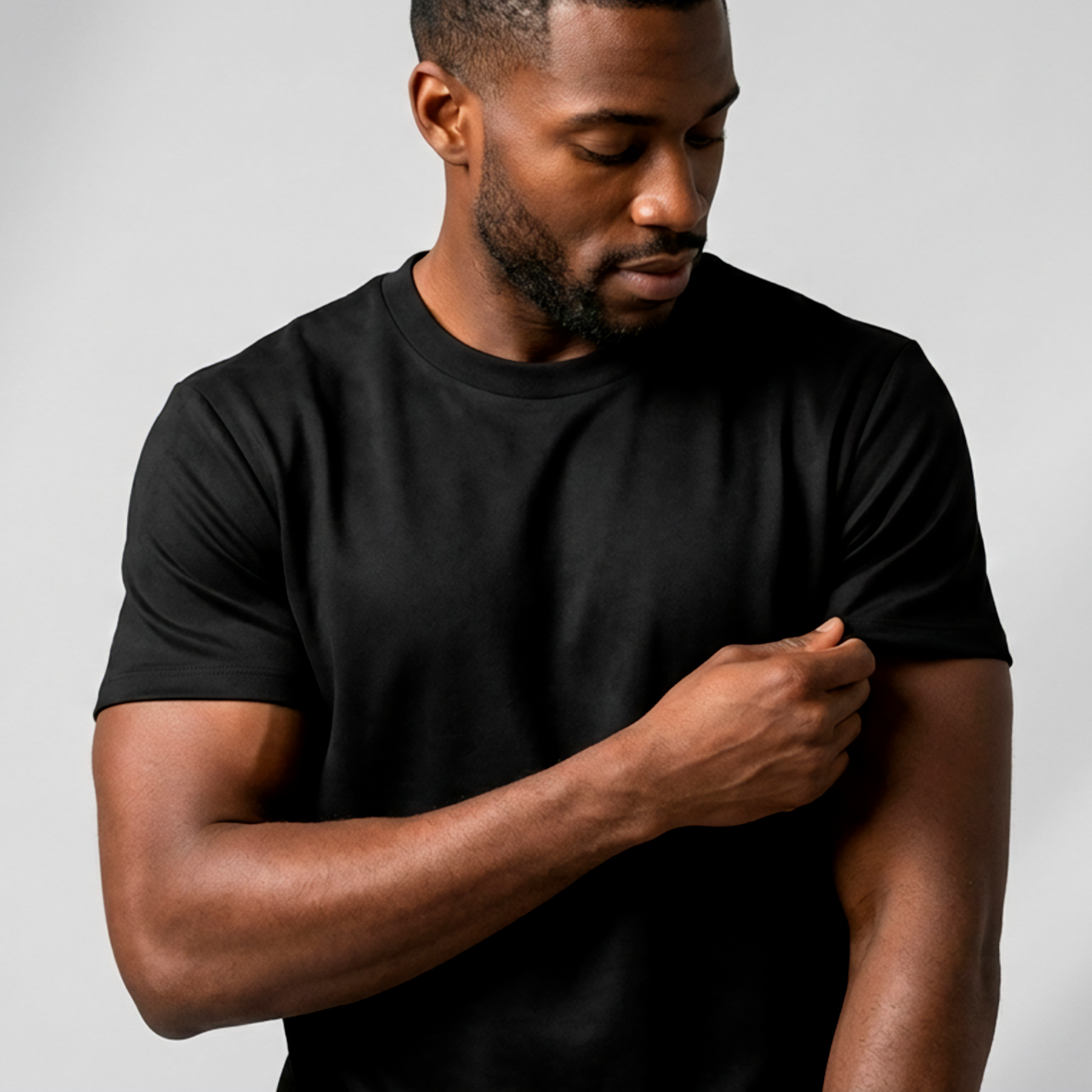 SuedeSkin Crew — men's black suede-feel crew neck t-shirt, on model